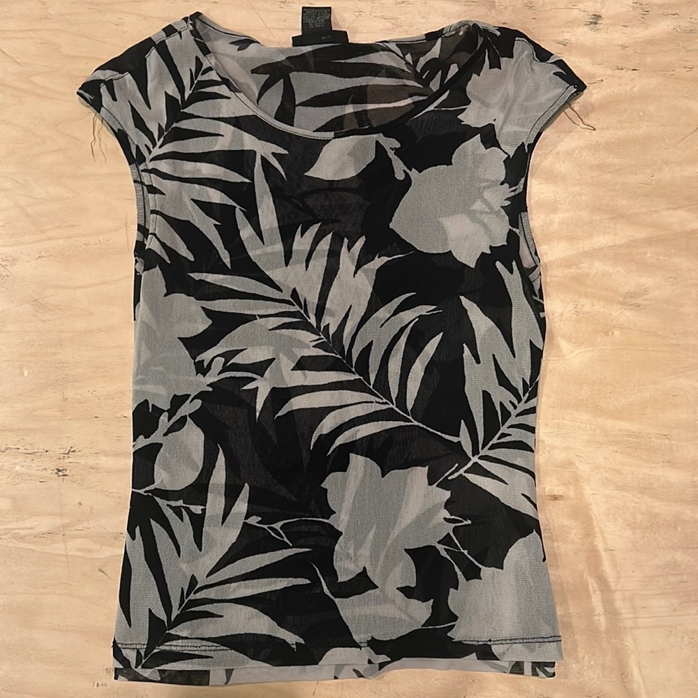 The Limited sheer leaf designed shell. Double layered for coverage.